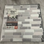 Smart Tiles Crescendo Agati Gray 9.73X9.36 In. Peel And Stick Vinyl TILE(4-PACK) New. Price: $14.00.