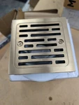 Delta DT062412-CZ 4" Tile-in Square Shower Drain Champagne Bronze Open. Price: $85.00.