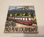 Vintage Pikes Peak Cog Railway Tile Enamel Trivet Wall Earthtones Hot Plate New. Price: $19.99.