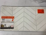 SM1179G-02-QG Blok Chevron White Vinyl Peel & Stick Tile, 22.56"X11.58", 2-PACK Open. Price: $17.26.
